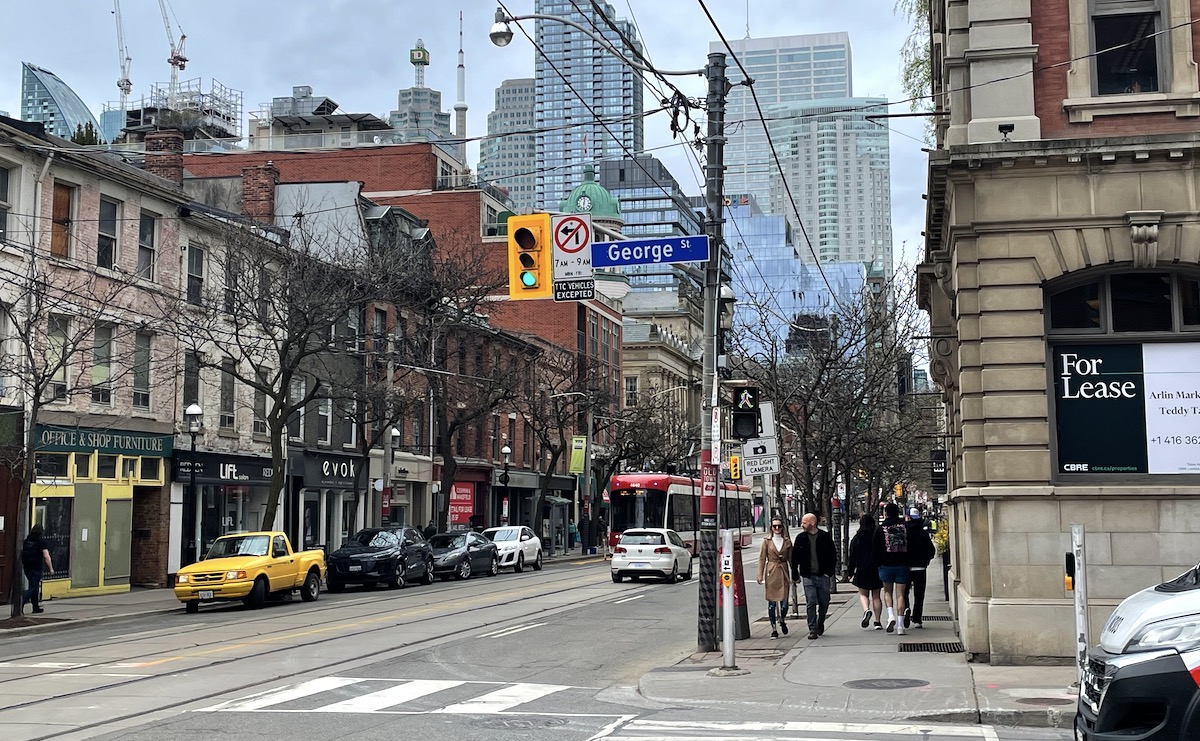 The intersection of King and George Street, in downtown Toronto. The light is green.